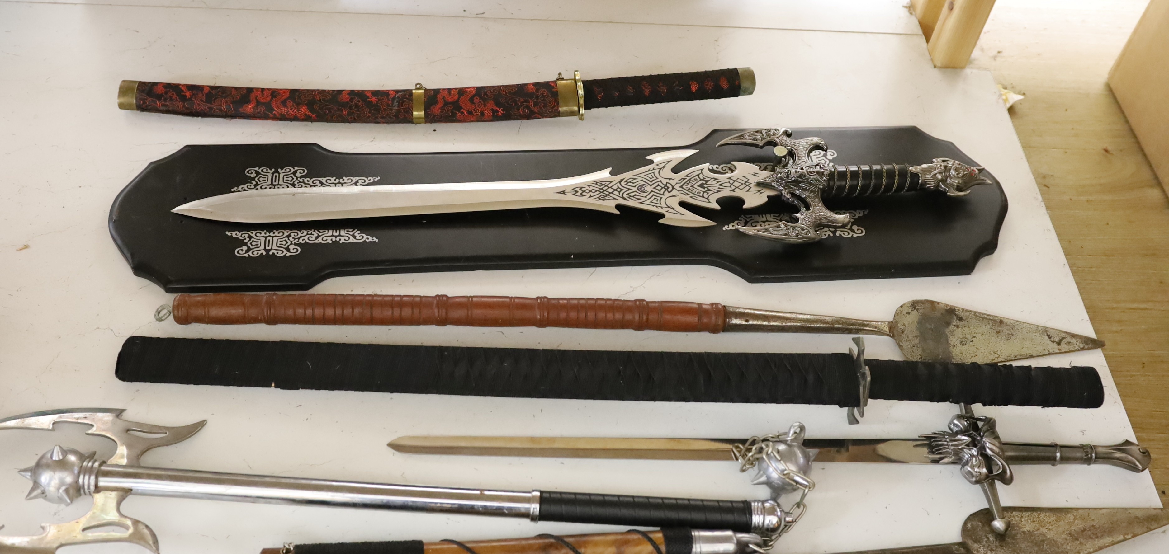A group of reproduction swords and weapons